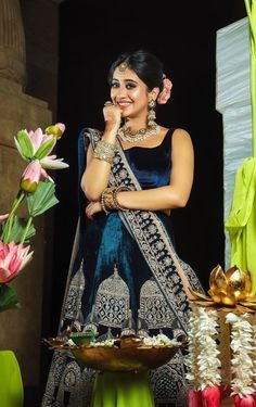 a woman in a blue and green lehenga