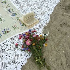 flowers are laying on the ground next to a tablecloth