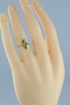 "14K Yellow Gold Emerald and Diamond Accent Ring, 3x5mm oval green center, 2 diamond accents, 9/16\" across ring, modernist bypass design, missing stone, Circa 1970, 2.5 grams Stock # BB231R21 Most rings are sizable for a small fee. If the ring you are considering is the incorrect size contact us for a quote. This listing contains photographs of the actual item you will receive. Our items are in excellent condition with little or no signs of wear and many are one of a kind pre-owned estate finds Green Modernist Rings For Anniversary, Modernist Green Rings For Anniversary, Modernist Green Ring For Formal Occasions, Heirloom 14k Gold Emerald Ring Collectible, Mid-century Green Formal Jewelry, Antique Gold Multi-stone Emerald Ring, Elegant 14k Gold Multi-stone Emerald Ring, 14k Gold Multi-stone Emerald Ring As A Gift, Green Modernist Oval Jewelry