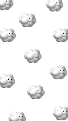 many white clouds floating in the air on a white background with no one around them