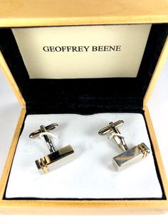 Cuff Links Vintage Geoffrey Beene In Original Box  ITEM: A striking pair of cufflinks from designer Geoffrey Beene in their original wooden presentation box. Contemporary design, from the late 80s to early 90s, they are a classic look with sleek modern lines and simple yet elegant finish. Highly lustrous chrome with an anodized gold stripe, they are a mallet shape with the standard flip back or levered back stays. Extremely stylish, they cut a sharp outline that makes them suitable for any occas Contemporary Vintage, Geoffrey Beene, Elephant Bracelet, Mens Formal Wear, Early 90s, Gold Stripes, Tie Accessories, Pink Bracelet, Cuff Links