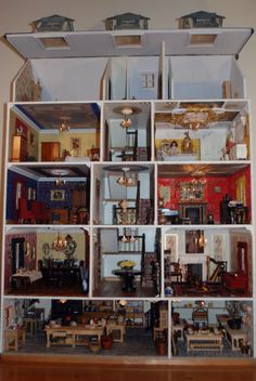 a doll house with all the furniture and accessories arranged in it's display case