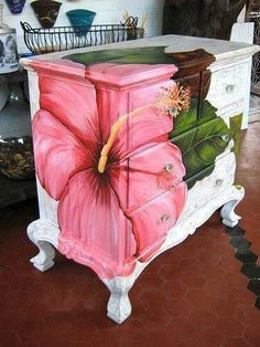 a painting of a pink flower on an old dresser