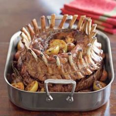 some meat and potatoes in a pan on a table