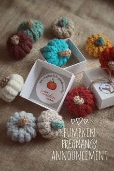 there are crocheted pumpkins and boxes on the table