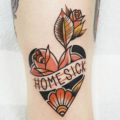 a heart tattoo with flowers and the words home sick on it