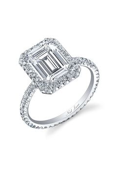 an emerald cut diamond ring with diamonds around it