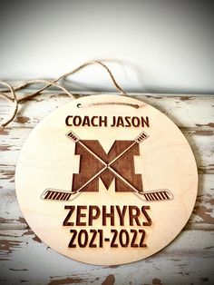 a wooden sign that says coach mason zephars