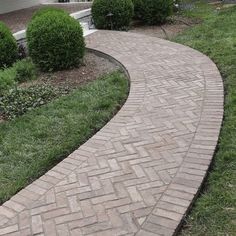 a brick walkway in front of a house