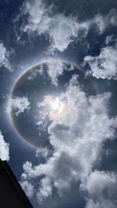 the sun is shining brightly through the clouds in the sky, while an object appears to be hovering above it