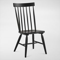 a black wooden chair on a white background with no one in the room to see it