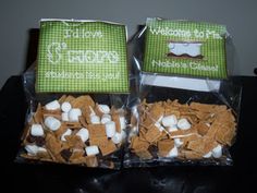 two bags filled with marshmallows on top of a table