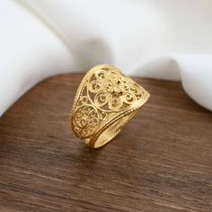 Elevate Your Style with the Gold-Plated Sterling Silver Filigree Art Lace Flower Cocktail Ring A Statement of Elegance and Femininity Elevate your style with the Gold-Plated Sterling Silver Filigree Art Lace Flower Cocktail Ring. This striking statement ring is meticulously handcrafted from 925 sterling silver and boasts luxurious gold plating. The intricate filigree art is adorned with delicate lace flower detailing, adding a touch of femininity and timeless elegance to your look. Perfectly Siz Bohemian Gold Filigree Ring For Wedding, Gold Bohemian Filigree Wedding Ring, Bohemian Gold Filigree Wedding Ring, Gold Bohemian Filigree Rings, Bohemian Gold Filigree Rings, Sterling Silver Filigree, Lace Embroidery, Filigree Ring, Lace Flowers