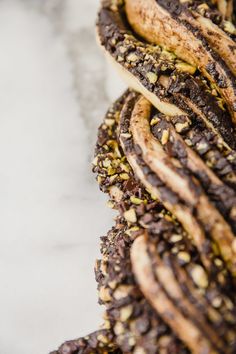 some kind of food that is on top of a white tablecloth and it looks like they are made out of cookies