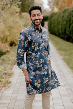 Whether it's a Fall sangeet state-side, or an Indian wedding on the beach, this floral print is the perfect floral that's not too over-the-top but will definitely get you on that best-dressed list. Pair this kurta with a pair of jeans for a casual, yet modern sangeet look or pair with dress pants for a more tailored evening mehendi look. Pairs well with the JEEVAN Pants in Cream or Wine. Details OEKO-Tex Certified 97% Cotton, 3% Elastane Metal Buttons from Italy Machine Wash Cold or Dry Clean It Sangeet Look, Mehendi Look, Wedding On The Beach, Kurta For Men, Kurta Men, Kurta Style, South Asian Wedding, Asian Wedding, Formal Looks