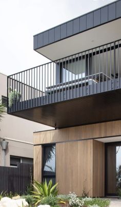 a modern house with wooden siding and balconies