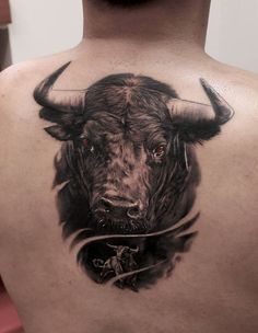 a man with a bull tattoo on his back