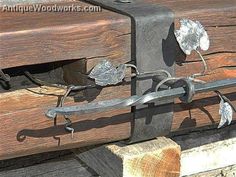 an old wooden bench with metal flowers on it