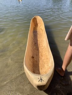 a person standing next to a boat in the water