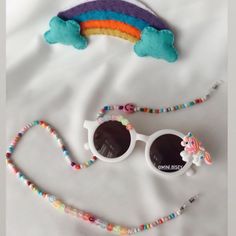 Wedding Days are special, so are the people involved in your special day, and the most precious among them is your little flower girl. Make a sweet gesture for your little flower girl. Gift them our unicorn shaped sunglasses and make them look beautiful and eye-catching in the crowd. These unicorn shaped sunglasses are the perfect flower girl gift for your bridal party. You can even make this the perfect flower girl proposal for your wedding. Features *The sunglasses have a special design and ar Rainbow Sunglasses With Uv Protection For Summer, Playful Tinted Lens Sunglasses For Festival, Fun White Adjustable Sunglasses, Whimsical Adjustable Sunglasses With Uv Protection, Playful White Sunglasses For Gift, Playful White Sunglasses As Gift, Playful White Sunglasses For Gifts, Adjustable Sunglasses With Gradient Lenses As Gift, Wedding Features