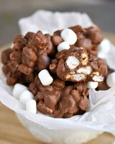 a bowl filled with marshmallows and chocolate