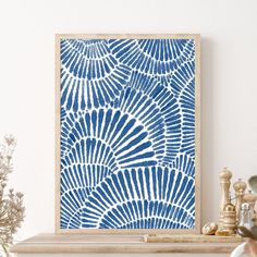 a blue and white painting on a mantle