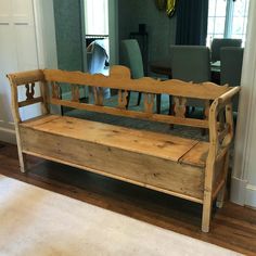 a wooden bench sitting in the middle of a living room