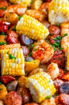 shrimp and corn on the cob with potatoes, carrots, and parsley