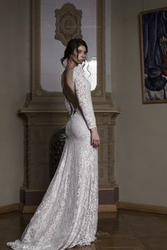 a woman in a white wedding dress posing for the camera