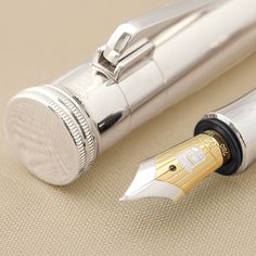 a close up of a fountain pen on a table