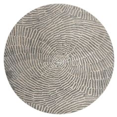 a round rug with an abstract design in grey and white on the inside of it