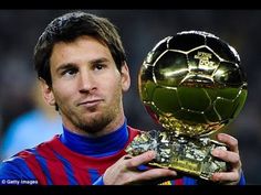 a man holding up a soccer ball trophy