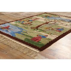 an area rug on the floor in a room with hardwood floors and wooden floors,