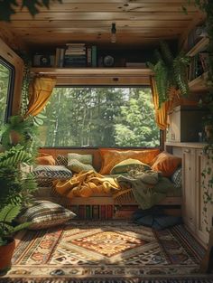 the inside of a camper with plants and pillows