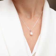 This drop shaped white pearl pendant exudes a stunning natural lustre and is suspended from 18" sterling silver diamond cut curb chain which has its own highly lustrous finish. An effortless piece of jewellery combining a timeless gem with a classic, understated design. The uncomplicated elegance of this pendant makes it ideal for weddings as well as a sophisticated, classic everyday look. Pearls are the oldest Gem known to man and have long been an emblem of modesty and purity. In Ancient Greek White Gold Pearl Necklace With Teardrop Pendant, White Gold Pearl Drop Necklace Gift, White Sterling Silver Drop Necklace With Pearl Pendant, Sterling Silver Drop Necklace With Pearl Pendant, White Pearl Pendant Drop Necklace In Sterling Silver, Sterling Silver White Drop Necklace With Pearl Pendant, White Gold Pearl Pendant Necklace In Drop Shape, Classic White Pearl Pendant Drop Necklace, White Gold Pear-shaped Pearl Drop Necklace