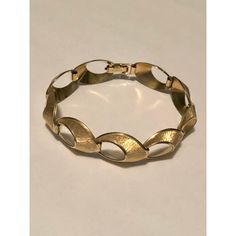 This is part of Chairish’s Fine Jewelry assortment.  This lovely 1940s Krementz 14k Gold Overlay Open Oval Link Bracelet, which comes in its original box, is a vintage piece to treasure. This traditional bracelet has nine (9) open oval links, each designed with brushed gold finish set against polished gold trim which adds depth and interest to this mid-century style bracelet. If you are a lover of sophisticated vintage jewelry, this bracelet will be a fabulous addition to your collection. It would make a fabulous gift as well.  Dimensions: 7.5"L including the clasp; approx. 1" Wide Condition: Excellent vintage condition with no wear to gold overlay (even on clasp); the clasp works very well and the links move smoothly. Please see pics for details. Original box is worn. Marks: KREMENTZ  Abo Gold Oval Bracelet Stamped 14k, Heirloom Metal Bracelets For Formal Occasions, Heirloom Style Metal Bracelets For Formal Occasions, Gold-tone Oyster Bracelet For Formal Occasions, Formal Gold-tone Oyster Bracelet, Classic Gold Jubilee Bracelet In Brass, Classic Brass Gold Jubilee Bracelet, Elegant Gold Brass Bracelet For Formal Occasions, Elegant Hinged Gold Bracelet As Gift