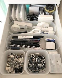 an organized drawer is shown with various items in the drawers, including scissors and other office supplies