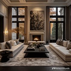 a living room filled with furniture and a fire place in front of two large windows