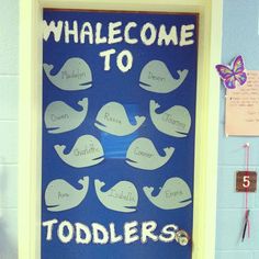 a blue door with white whale silhouettes and the words whales to toddlers written on it