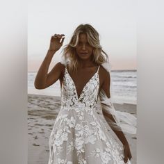 a woman in a white dress on the beach