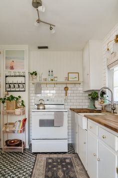 a white stove top oven sitting inside of a kitchen