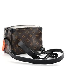 This is an authentic LOUIS VUITTON Monogram Solar Ray Mini Soft Trunk. This chic shoulder bag from Virgil Abloh's collection is featured in classic Louis Vuitton monogram canvas in brown. The shoulder bag features a black leather shoulder strap with matte black chain links and bright orange hardware. The top zipper opens to a black fabric interior with a patch pocket. Chain Links, Black Chain, Bright Orange, Monogram Canvas, Authentic Louis Vuitton, Black Fabric, Chain Link, Louis Vuitton Monogram, Patch Pocket