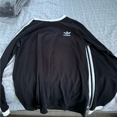 Brand New Adidas Sweatshirt Never Worn. Does Not Fit But Very Comfortable. Black Long Sleeve T-shirt With Ribbed Cuffs, Casual College Tops With Three Stripes, Casual Three Stripes Tops For College, Adidas Three Stripes Tops For Streetwear, Adidas Three Stripes Streetwear Top, Adidas Streetwear Tops With Three Stripes Branding, Adidas Tops With Three Stripes For Streetwear, Sporty Crew Neck Top With Three Stripes, Streetwear Crew Neck Tops With Three Stripes