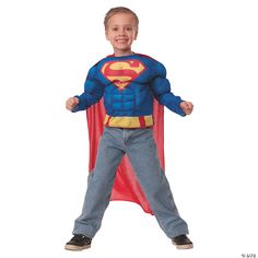 a young boy dressed in a superman costume