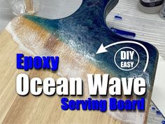 a wooden cutting board with the words epoxy ocean wave serving board