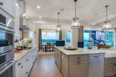 a large kitchen with an island and stainless steel appliances