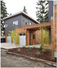 a modern house with wood siding and garage