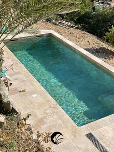 an empty swimming pool surrounded by trees and rocks