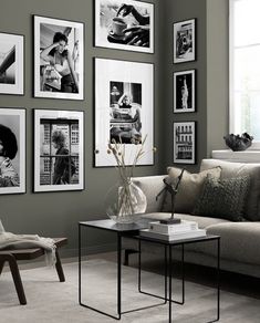 a living room filled with lots of pictures on the wall and furniture in front of it