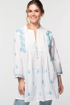 Our Kamalika Tunic is hand embroidered by women artisans in Northern India in the shadow-work style known as "Chikankari". Chikankari is a delicate and artfully done hand embroidery technique that women in this region have been doing for generations.  Available in two sizes, S/M and L/XL, this beautiful 100% cotton tunic is designed for a comfortable and elegant fit. Festive Traditional Tops With Tonal Embroidery, Summer Chikankari Embroidery Fabric, Summer Chikankari Embroidered Fabric, Bohemian Chikankari Embroidered Fabric, Bohemian Chikankari Embroidered Top For Festive Occasions, Festive Folk Embroidered Top, Spring Bohemian Kurta With Motifs, Bohemian Spring Kurta With Motifs, Bohemian Chikankari Embroidered Fabric For Summer